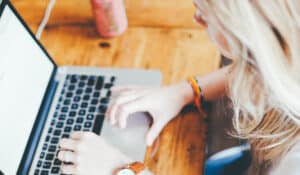 Successful PR - Woman typing on macbook keyboard. Mosaic's top tips for successful PR - Mosaic Publicity