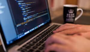 Web Design - Person writing code on macbook keyboard